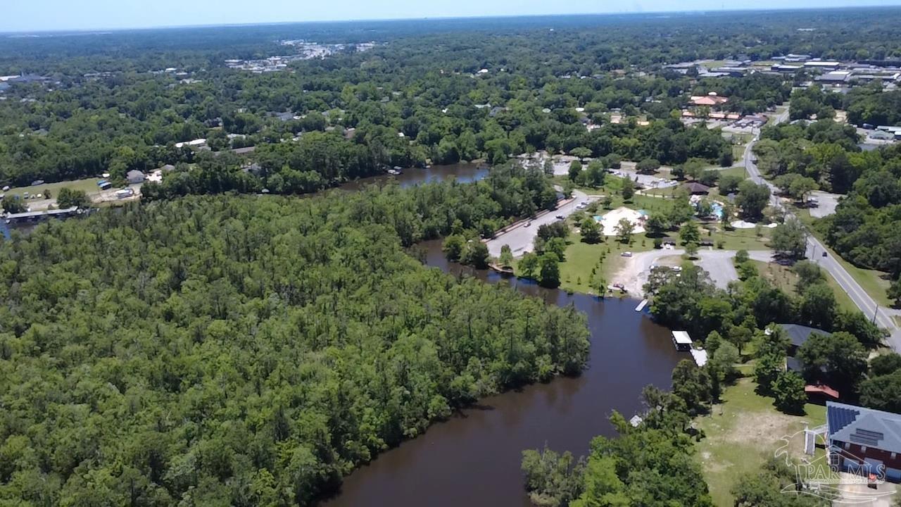 0 Broad Street Milton, FL 32570 - Photo 6 of 28 an aerial view of green landscape with trees and houses