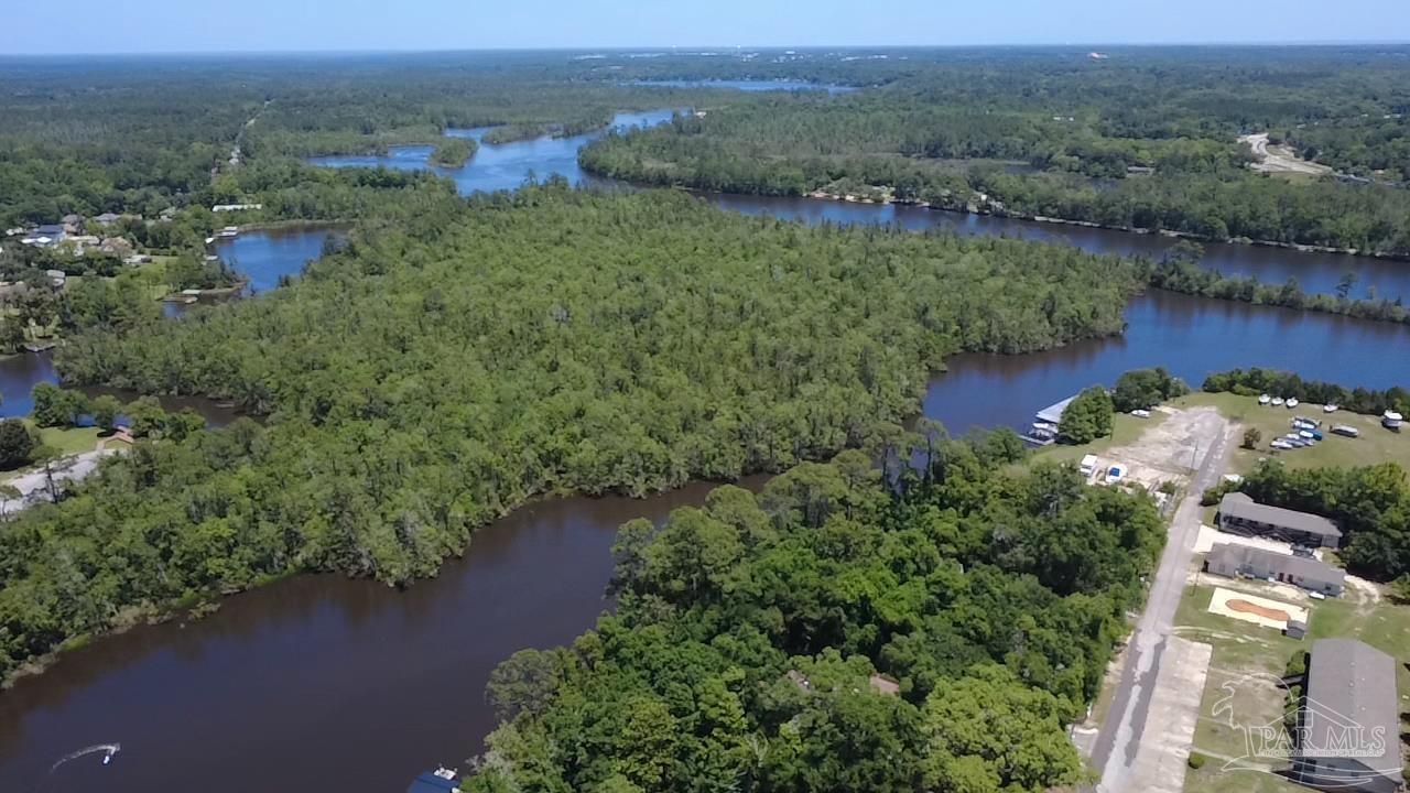 0 Broad Street Milton, FL 32570 - Photo 7 of 28 an aerial view of green landscape with trees houses and lake view