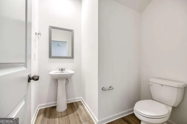 a white toilet sitting next to a sink