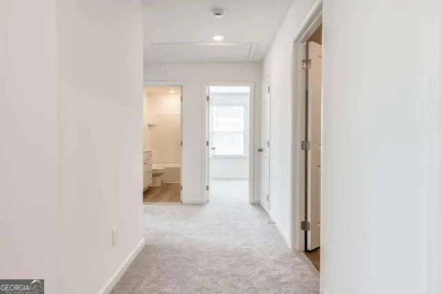 a view of a hallway with wooden shelves