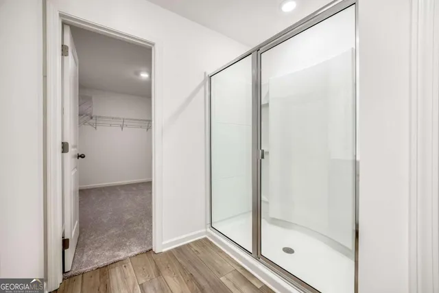 a bathroom with a glass shower door