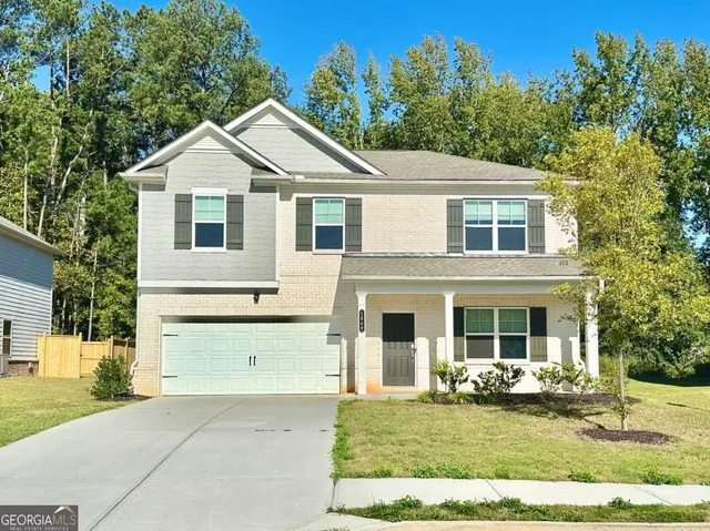 a front view of a house with a yard