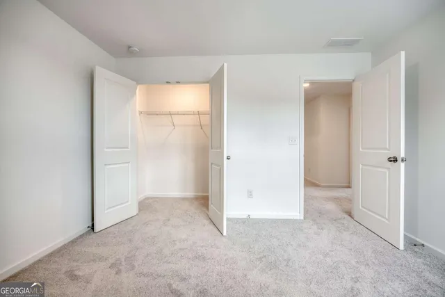 an empty room that has a grey walls