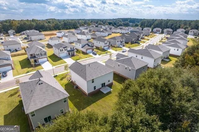 an aerial view of residential houses with outdoor space