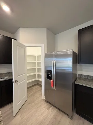 a kitchen with a refrigerator and microwave