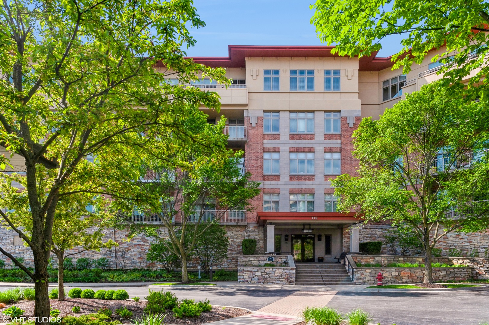 115 Prairie Park Drive, Unit 407 Wheeling, IL 60090 - Photo 1 of 17 a front view of a building with garden