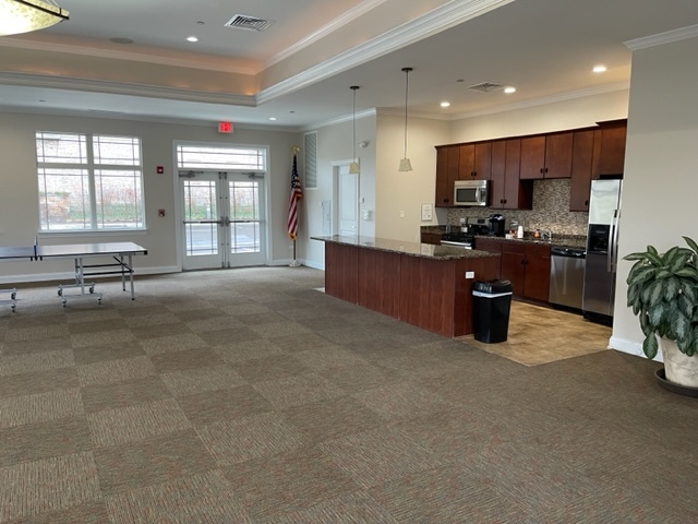 115 Prairie Park Drive, Unit 407 Wheeling, IL 60090 - Photo 17 of 17 a large living room with stainless steel appliances furniture a rug and a view of kitchen