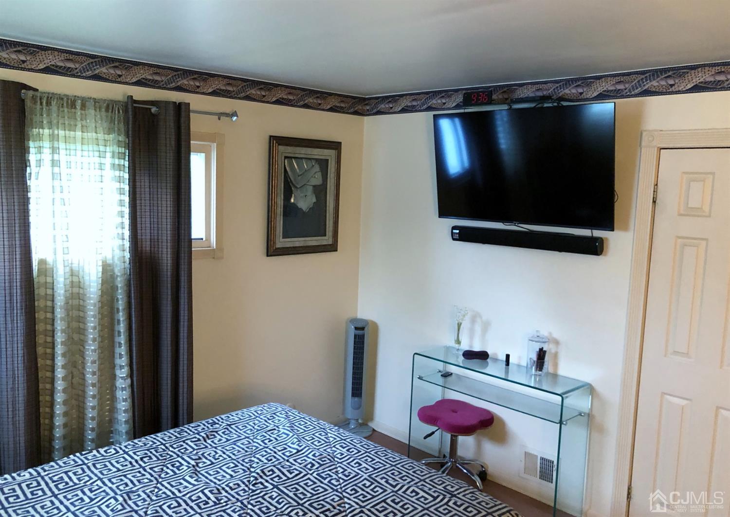 4 Brandeis Road Old Bridge, NJ 08859 - Photo 13 of 24 a bedroom with a bed and flat screen tv