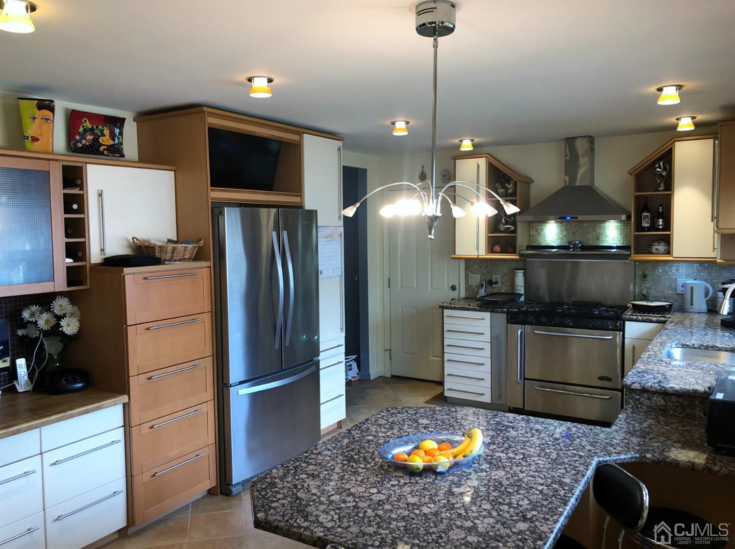 4 Brandeis Road Old Bridge, NJ 08859 - Photo 3 of 24 a kitchen with a refrigerator a stove and a wooden floor