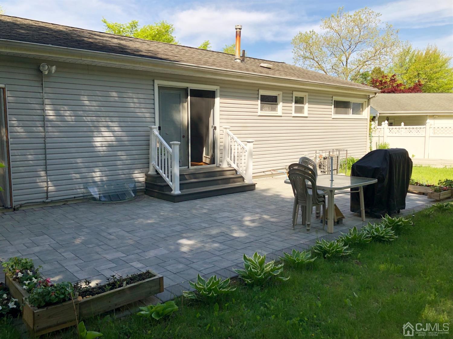 4 Brandeis Road Old Bridge, NJ 08859 - Photo 23 of 24 a view of backyard with table and chairs and potted plants