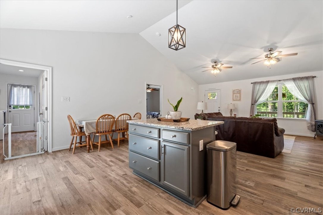1820 Ballsville Road Powhatan, VA 23139 - Photo 11 of 46 a kitchen with stainless steel appliances granite countertop a stove top oven a refrigerator a dining table and chairs with wooden floor
