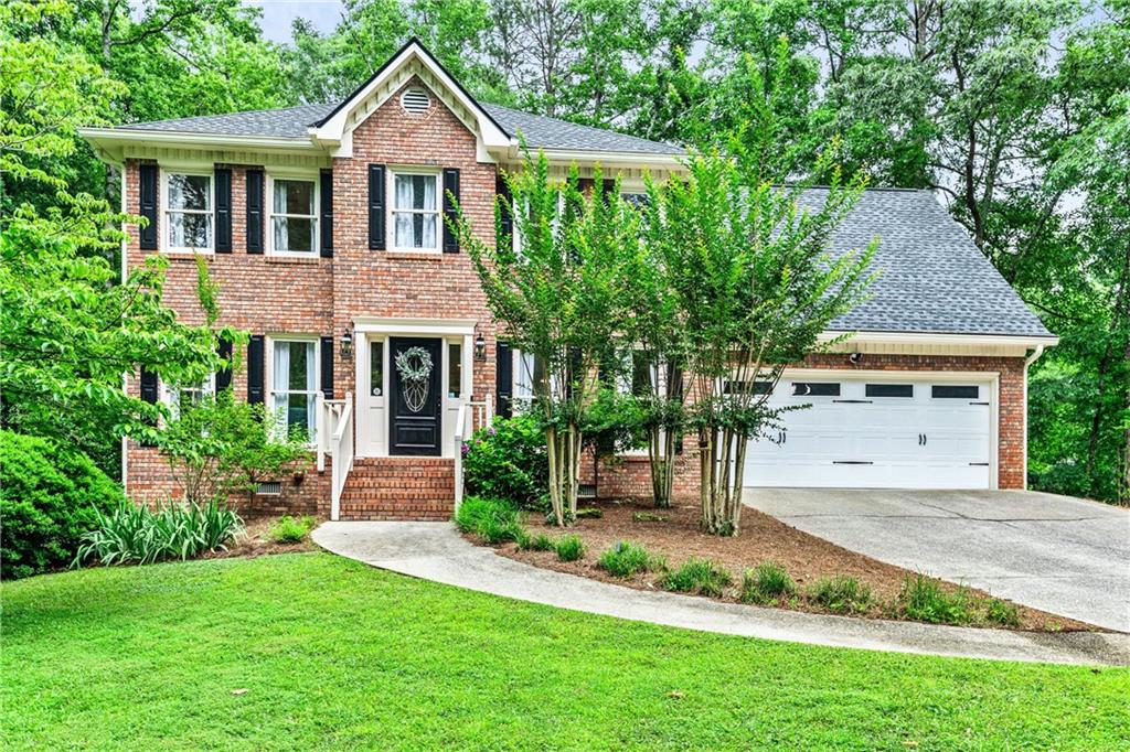 a front view of a house with a yard