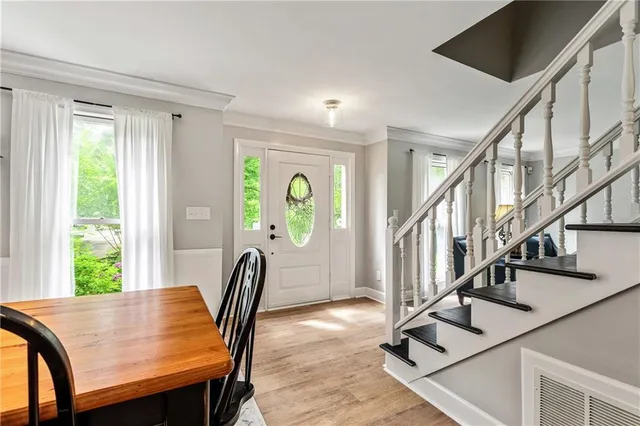 a view of a dining room with furniture window and wooden floor
