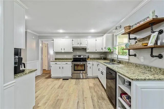 a kitchen with a stove a sink and a refrigerator