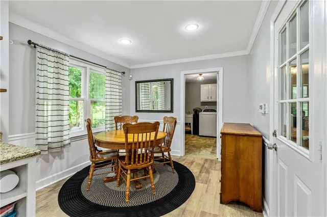 a dining room with furniture and wooden floor