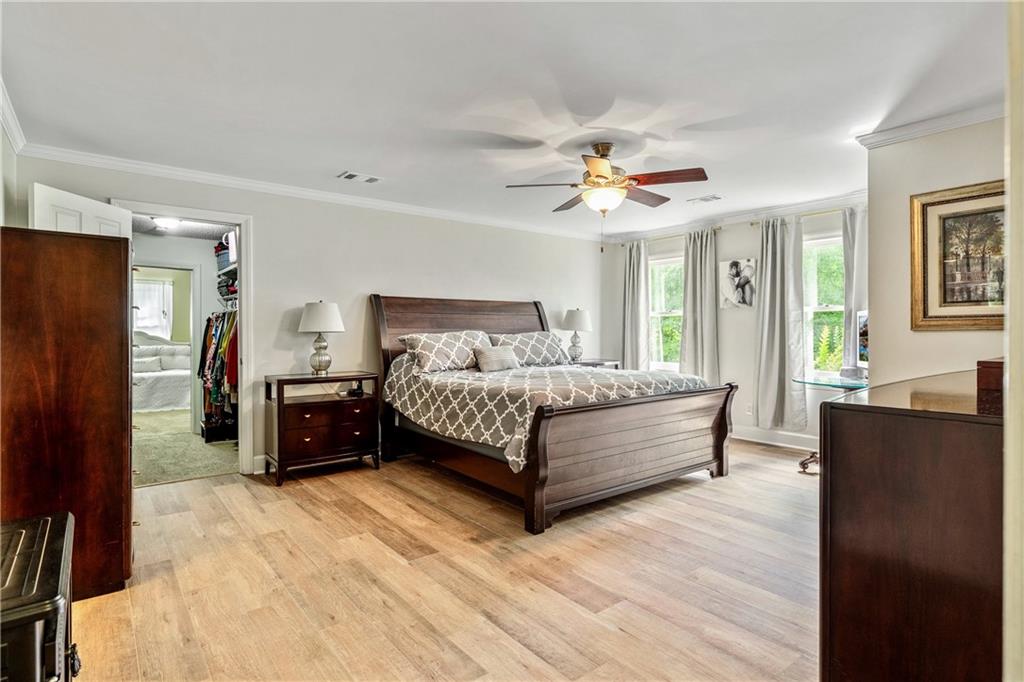 135 Crimson Ridge Tyrone, GA 30290 - Photo 32 of 53 a bedroom with a bed and a chandelier