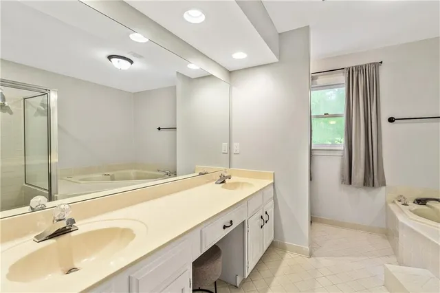 a spacious bathroom with a tub and shower