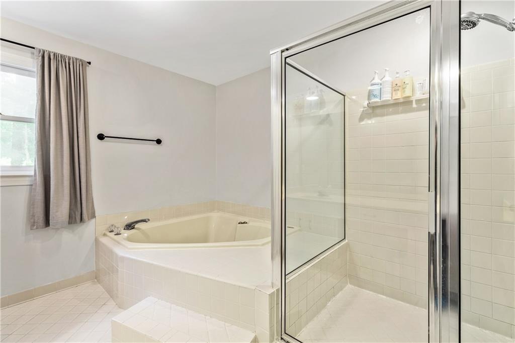 135 Crimson Ridge Tyrone, GA 30290 - Photo 35 of 53 a white bath tub sitting next to a shower