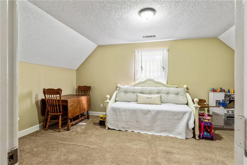 135 Crimson Ridge Tyrone, GA 30290 - Photo 37 of 53 a bedroom with furniture and a window