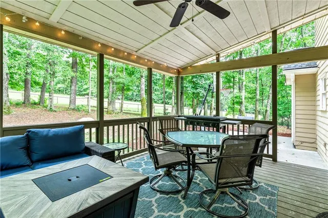 a view of a house with backyard and sitting area