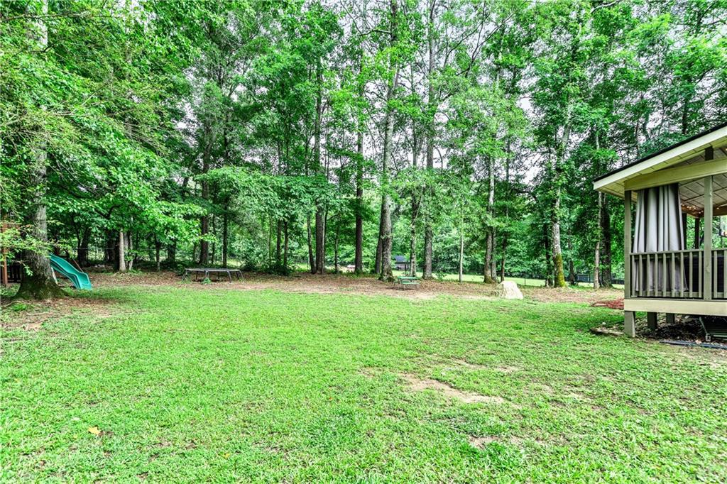 135 Crimson Ridge Tyrone, GA 30290 - Photo 46 of 53 a view of a backyard with a garden and trees