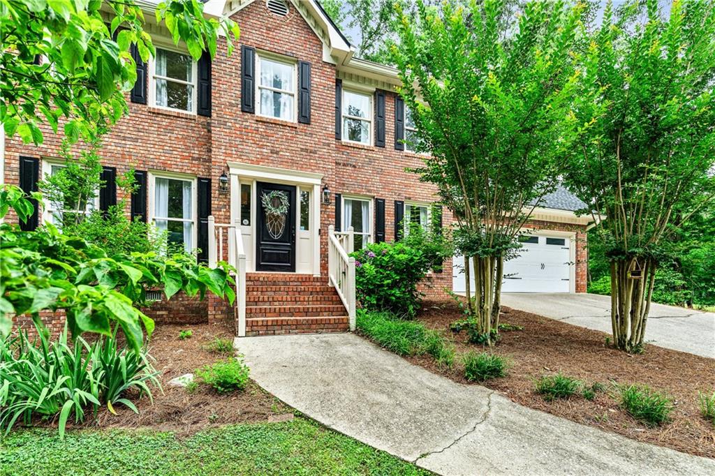 135 Crimson Ridge Tyrone, GA 30290 - Photo 8 of 53 a front view of a house with a garden