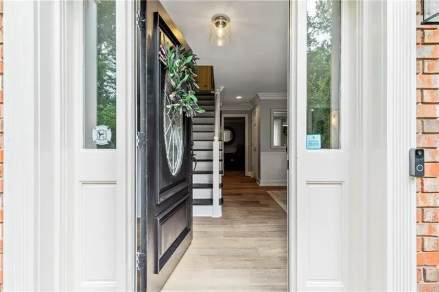 a view of a hallway with wooden shelves