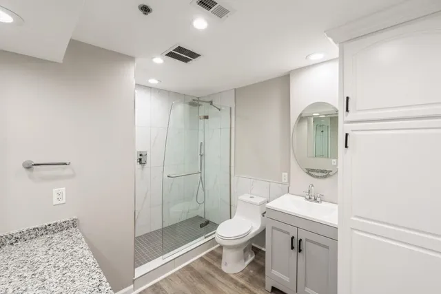 a bathroom with a sink toilet and shower