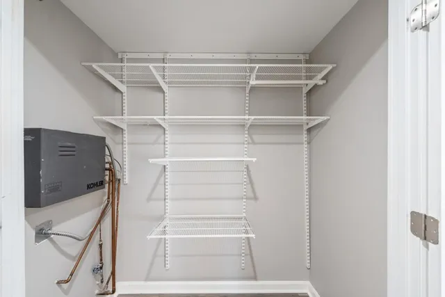 a view of walk in closet with empty racks