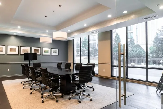 a view of a dining room with furniture and floor to ceiling window
