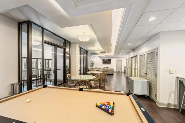 a very nice looking room with a large window and furniture