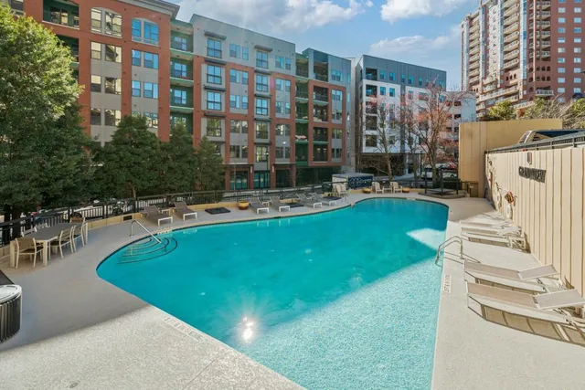 a swimming pool with outdoor seating and yard