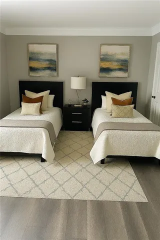 a bedroom with bed and a painting on the wall