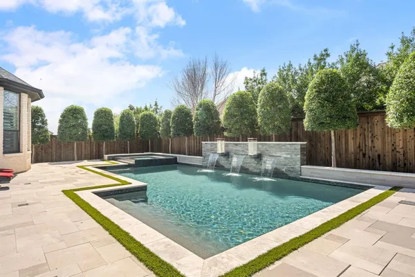 a view of a backyard with swimming pool