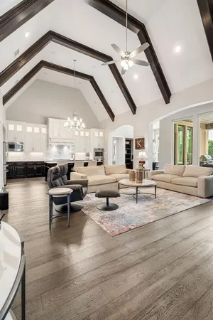 a living room with lots of furniture and a chandelier