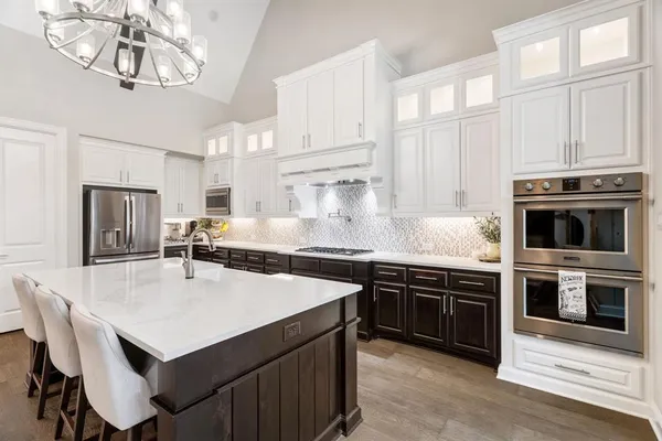 a kitchen with a stove a sink and a refrigerator