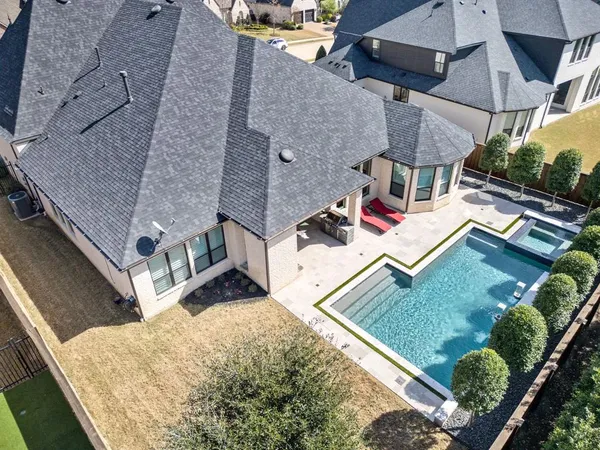 an aerial view of a house with a yard