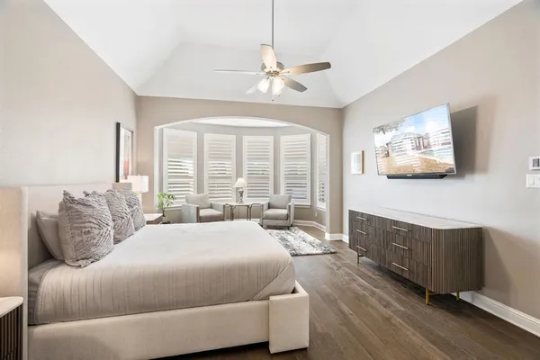 a bedroom with a large bed and a couch