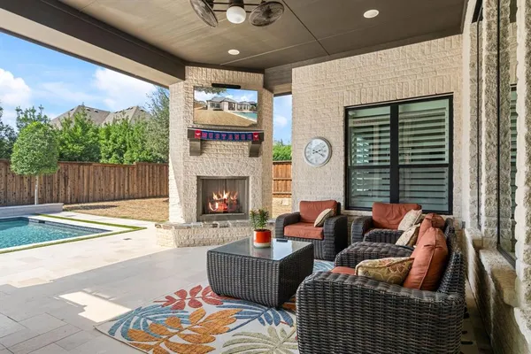 a outdoor living space with furniture and a fireplace