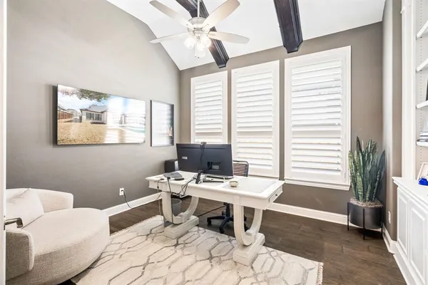 a bedroom with a bed and dresser with mirror