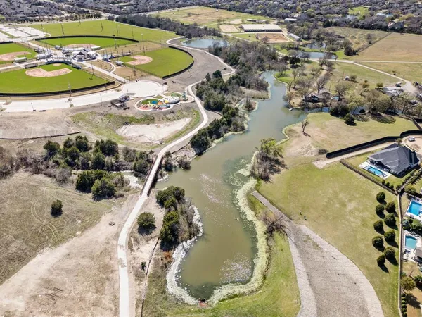 a front view of a house with parking yard and garage
