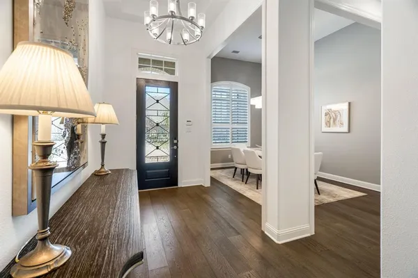 a view of a livingroom with wooden floor and a ceiling fan