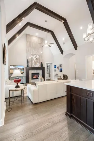 a living room with furniture a fireplace and a large window