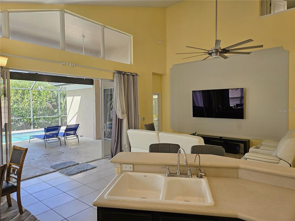 175 Braemar Avenue Venice, FL 34293 - Photo 11 of 40 a living room with furniture and a flat screen tv