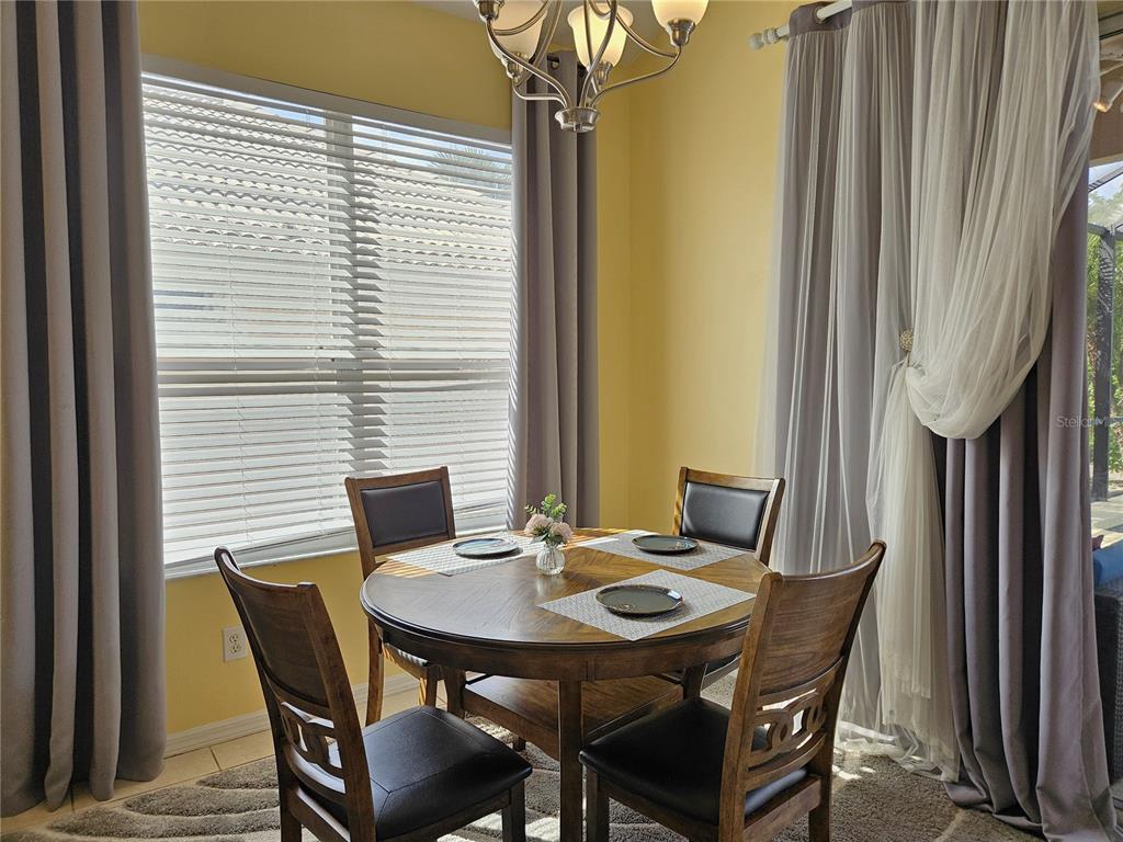 175 Braemar Avenue Venice, FL 34293 - Photo 12 of 40 a view of a dining room with furniture and window