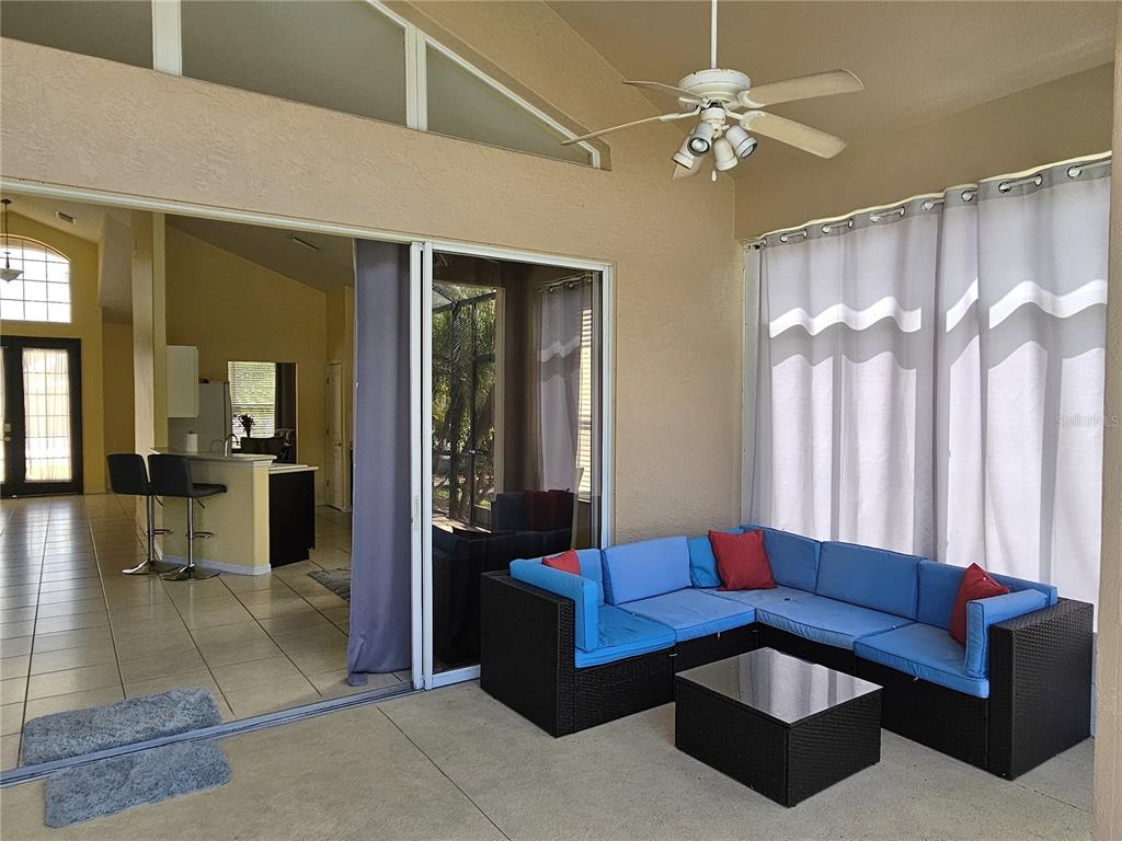175 Braemar Avenue Venice, FL 34293 - Photo 18 of 40 a living room with furniture and a chandelier