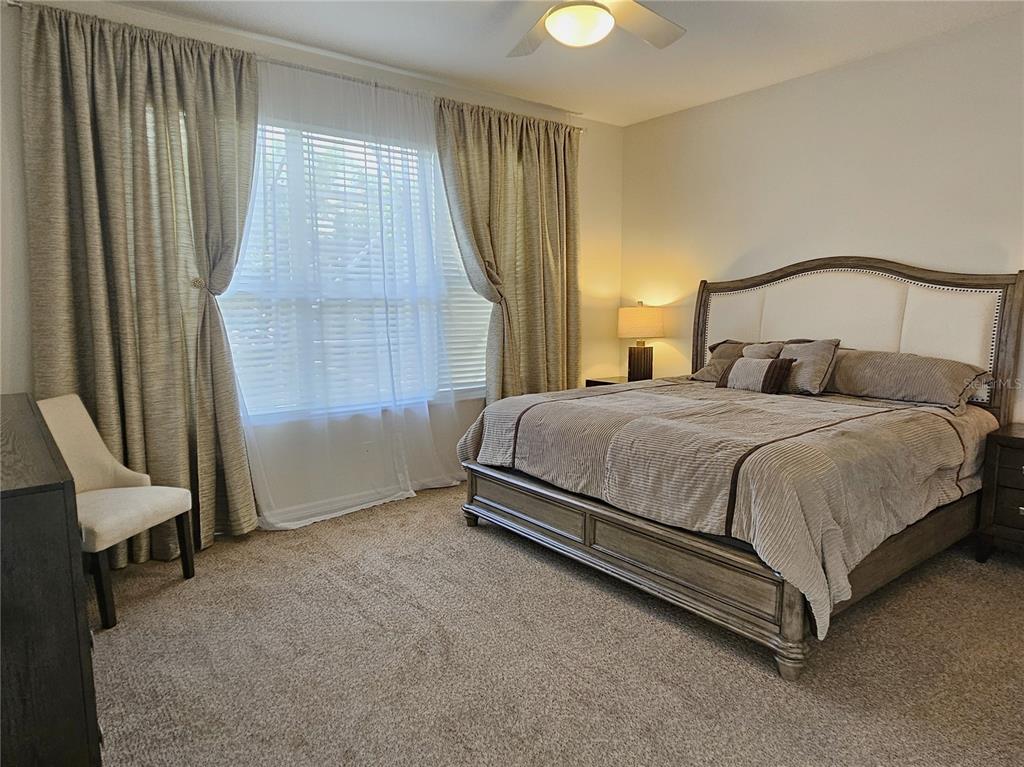 175 Braemar Avenue Venice, FL 34293 - Photo 21 of 40 a bedroom with a bed chair and window