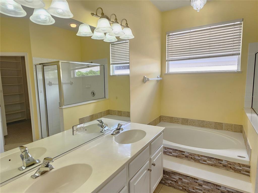 175 Braemar Avenue Venice, FL 34293 - Photo 23 of 40 a bathroom with a tub sink and mirror