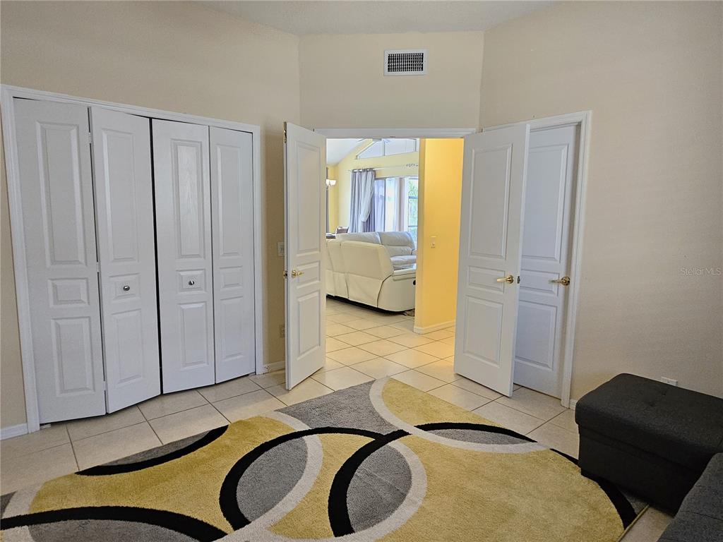175 Braemar Avenue Venice, FL 34293 - Photo 29 of 40 a bedroom with a bed and couch