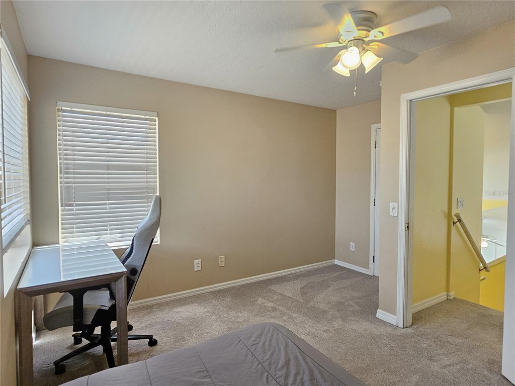 175 Braemar Avenue Venice, FL 34293 - Photo 34 of 40 a view of a livingroom with a chair and a ceiling fan